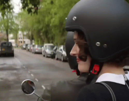 Woman in Helmet and Sunglasses Riding Scooter