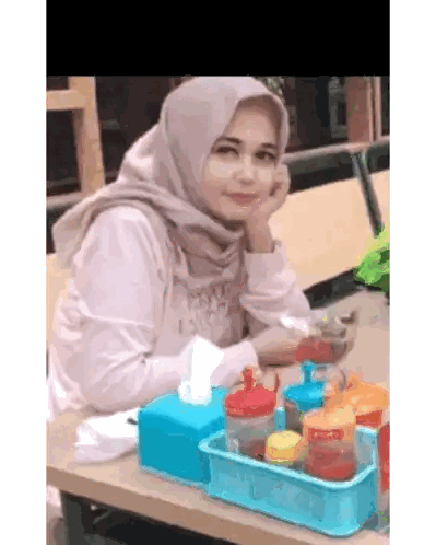 Woman in Hijab Sitting at Table