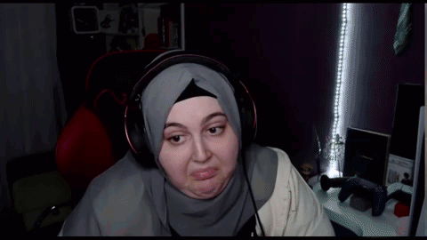 Woman In Hijab Wearing Headphones Making Face GIF
