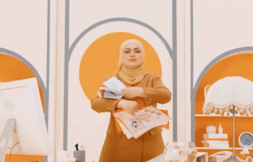 Woman in Hijab With Orange and White I Love You Papers