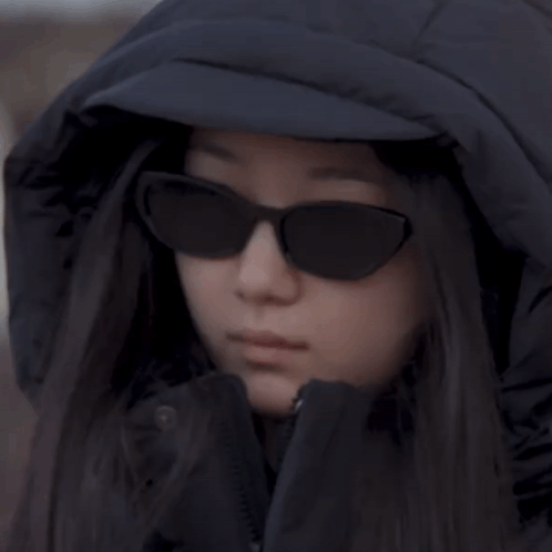 Woman in Hooded Jacket and Sunglasses