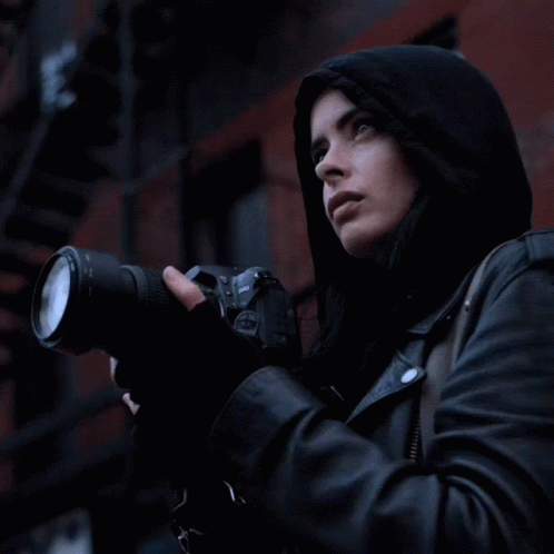Woman in Hooded Jacket Holding Nikon Camera