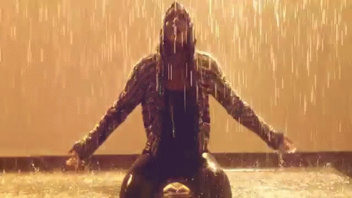 Woman in Hooded Jacket in Rain Arms Outstretched