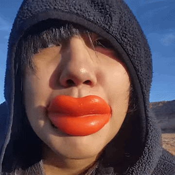 Woman in Hooded Jacket With Huge Red Lips