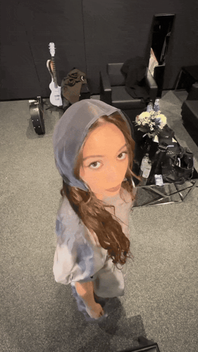 Woman in Hooded Shirt With Guitar