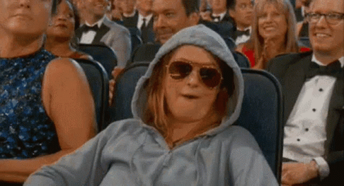 Woman in Hoodie and Sunglasses at Movie Theater