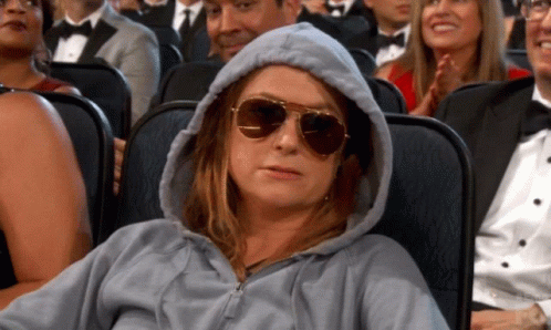 Woman in Hoodie and Sunglasses in Theater