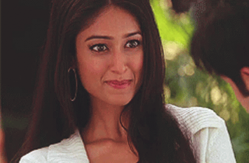 Woman in Hoop Earrings and White Jacket Smiling