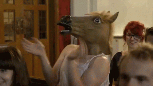 Woman in Horse Mask Waving at Group