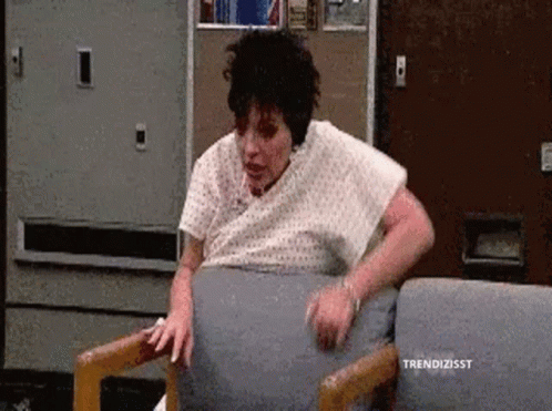 Woman in Hospital Gown Sitting