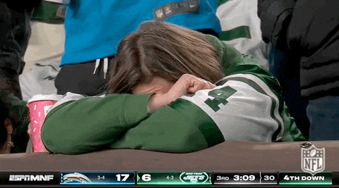 Woman In Jets Jersey Covering Face While Watching Game GIF