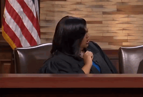 Woman in Judge's Robe Sitting at Table
