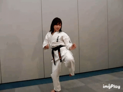 Woman In Karate Uniform Kicking GIF