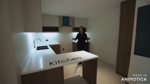 Woman in Kitchen With Word on Counter