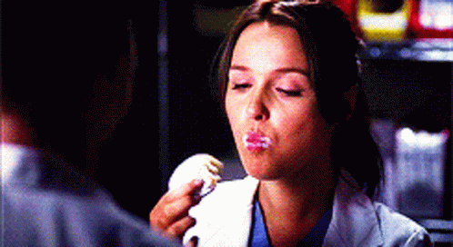 Woman in Lab Coat Eating Cake