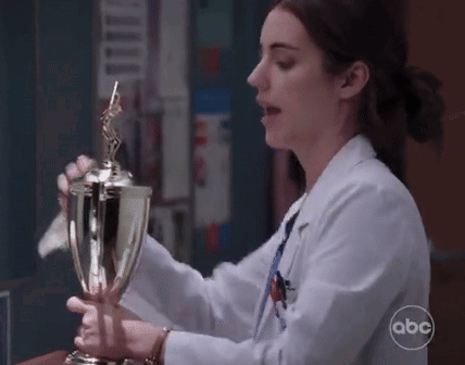 Woman In Lab Coat Holding Trophy ABC GIF