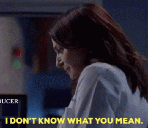 Woman in Lab Coat Saying I Don't Know What You Mean