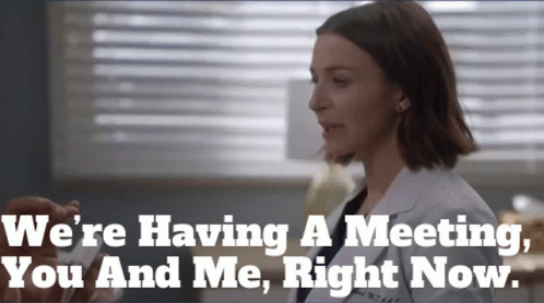 Woman in Lab Coat Saying We're Having a Meeting