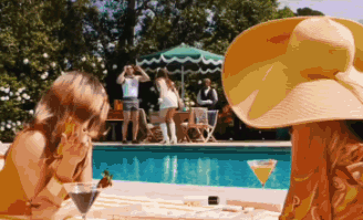 Woman in Large Hat Next to Pool