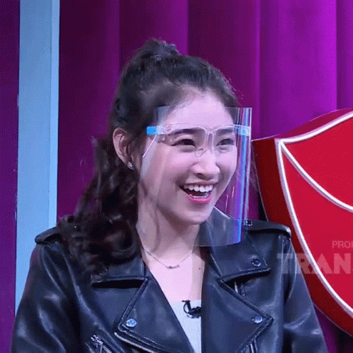 Woman in Leather Jacket and Face Shield Smiles