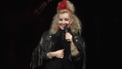 Woman in Leather Jacket Holding Microphone