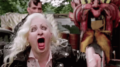 Woman In Leather Jacket Screaming At Mustache Statue GIF