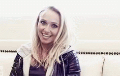 Woman In Leather Jacket Smiling At Camera GIF