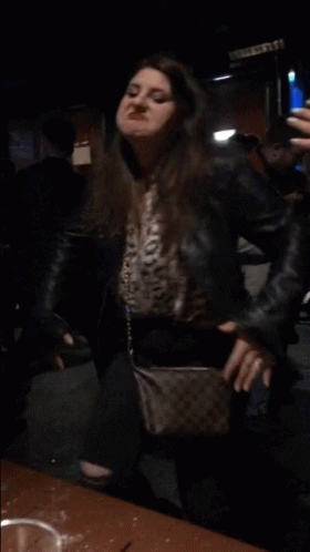 Woman In Leather Jacket Taking Mirror Selfie GIF