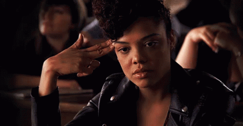 Woman In Leather Jacket With Finger On Forehead GIF