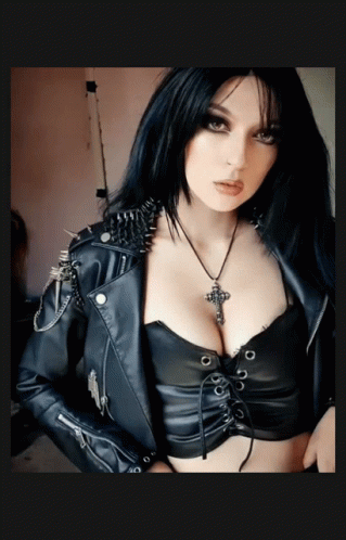 Woman in Leather Jacket with Spikes and Cross Necklace