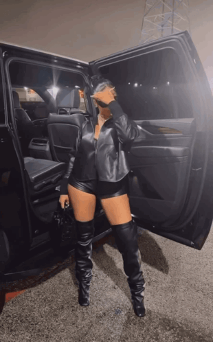 Woman in Leather Shorts and Thigh High Boots by Car