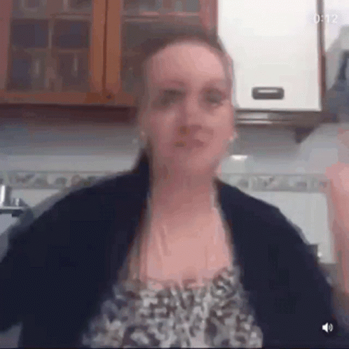 Woman in Leopard Print Arms Outstretched in Kitchen