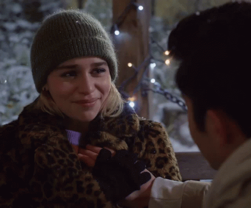 Woman in Leopard Print Coat and Beanie Holding Man's Hand