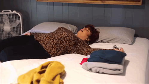Woman In Leopard Print Laying On Bed GIF