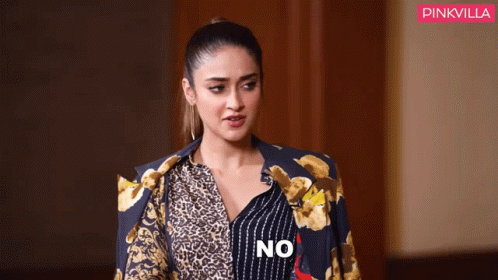 Woman in Leopard Print Shirt and Blue Jacket Saying No