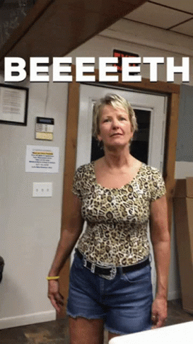 Woman In Leopard Shirt Standing In Front Of Door Saying Beeeeeth GIF