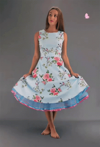 Woman In Light Blue Floral Dress And Pink Rose GIF