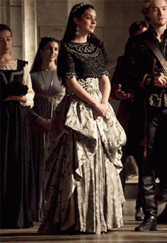 Woman in Long Dress with Group in Hallway