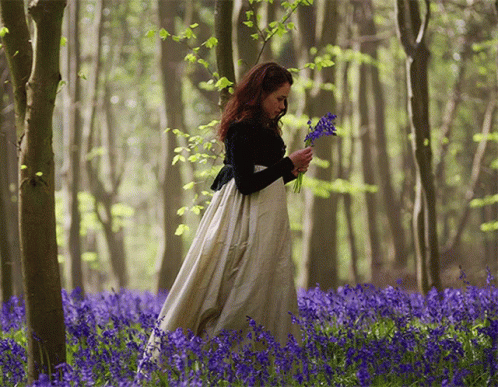 Woman in Long White Dress in Blue Flower Field