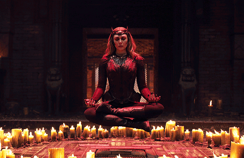 Woman In Lotus Position In Front Of Candles GIF