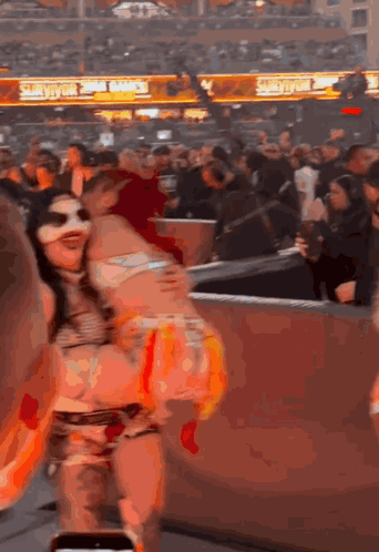 Woman in Mask Dancing at Stadium Smackdown Sign
