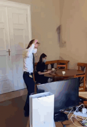 Woman In Mask Watching Man Dance GIF