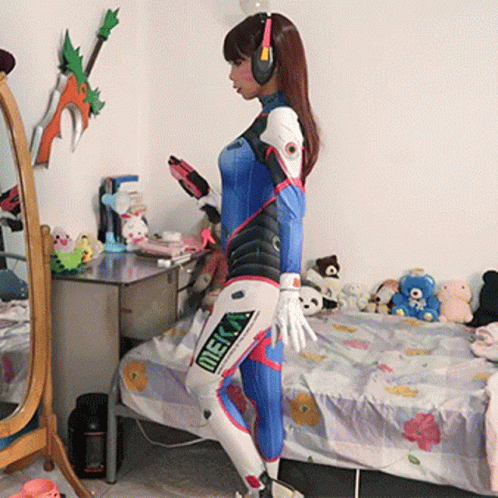 Woman In Meka Costume Standing In Front Of Bed GIF