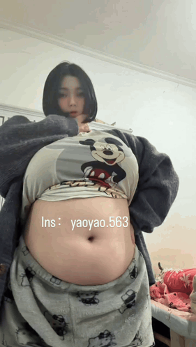 Woman in Mickey Mouse Shirt With Large Belly