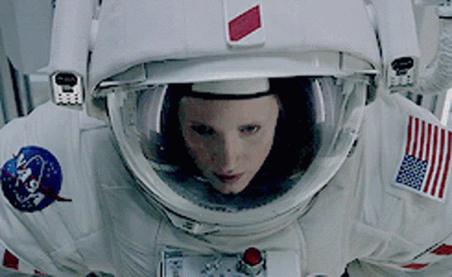 Woman In NASA Space Suit Looking At Camera GIF