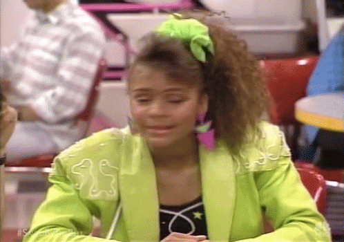 Woman in Neon Green Jacket Sitting at Restaurant Table