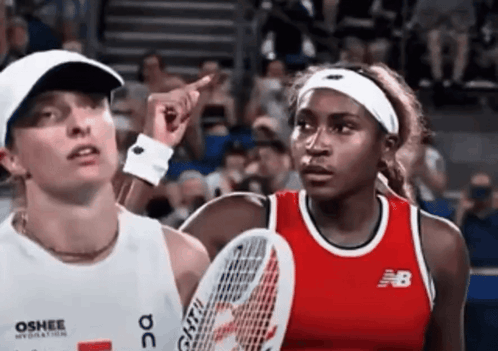 Woman in New Balance Shirt Points at Usopen.org Sign