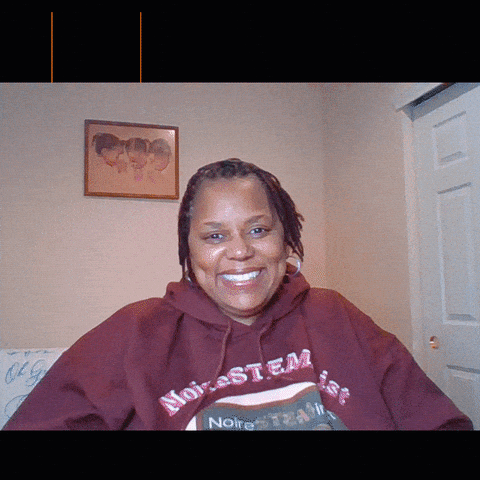 Woman in Noire Stem Hoodie Smiling