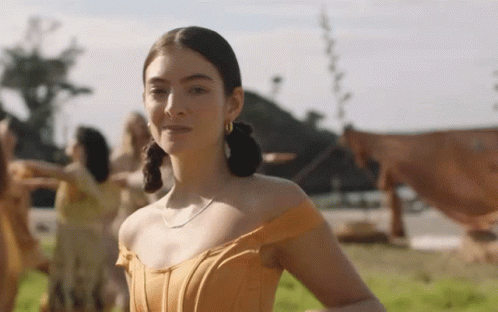 Woman In Orange Dress In Field GIF