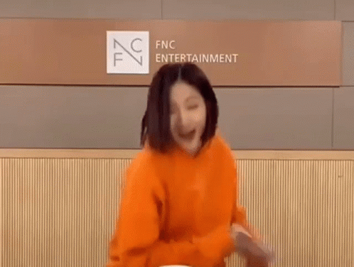 Woman in Orange Hoodie Dancing